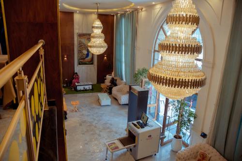 a living room with chandeliers hanging from the ceiling at 泊悦国际大酒店 BoYue Hotel in Addis Ababa Bole International Airport