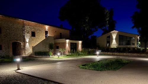 a building with lights in front of it at night at The Monteleone Umbria Retreat in Monteleone dʼOrvieto