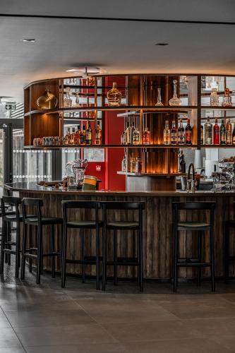 a bar in a restaurant with wooden tables and chairs at Thalazur Carnac in Carnac
