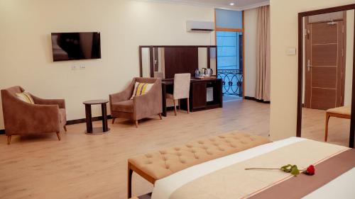 a hotel room with a bed and a living room at 泊悦国际大酒店 BoYue Hotel in Addis Ababa Bole International Airport
