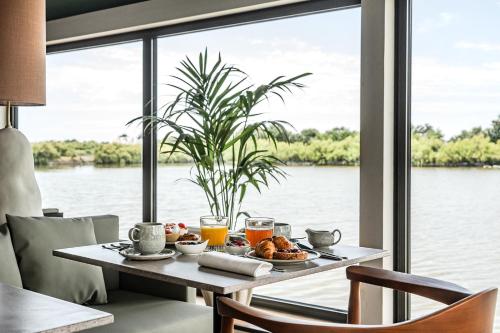 a breakfast table with a view of the water at Thalazur Carnac in Carnac