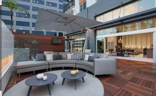 a living room with a couch and two tables at Disney Vacay 8 min Away in Irvine