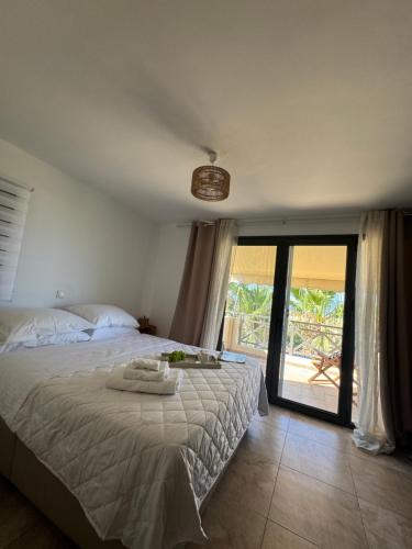 a bedroom with a bed and a sliding glass door at Aegina Horizon Stonehouse No I in Aegina