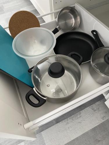 a bunch of pots and pans on a kitchen counter at Apartament Zoom 42 in Bydgoszcz