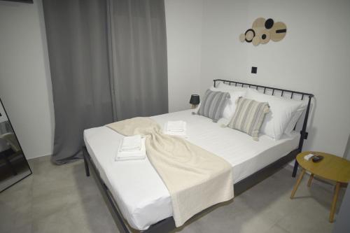 a bedroom with a bed with white sheets and pillows at Paul's Houses 2 in Drama