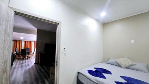 a bedroom with a bed with blue towels on it at The Blue Donkey in Paramaribo