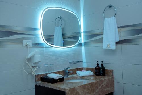 a bathroom with a sink and a mirror at 泊悦国际大酒店 BoYue Hotel in Addis Ababa Bole International Airport