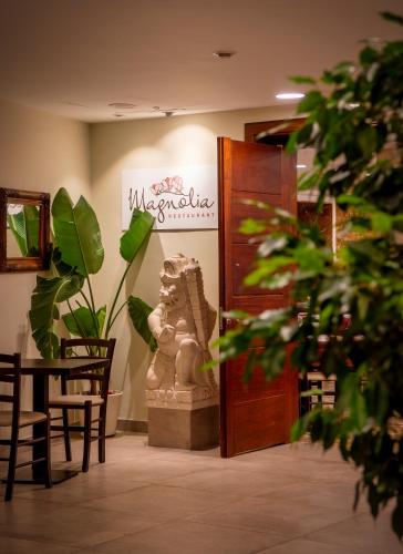 a room with a table and a statue next to a door at Hotel la Palmera & Spa in Lloret de Mar