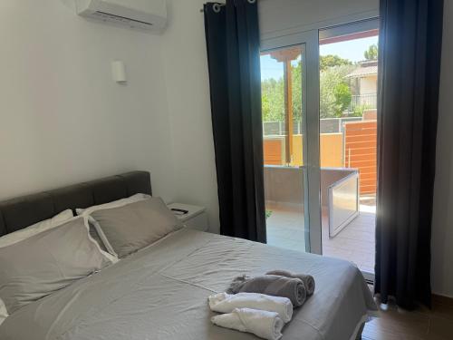 a bedroom with a bed with a towel on it at Maria House in Artemida