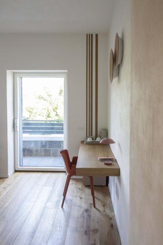 a room with a wooden desk and a window at Casale Nostos in SantʼAgata sui Due Golfi