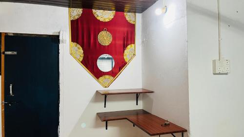 a room with a table and a flag on the wall at Coral Reef Malpe - Udupi in Udiyāvara