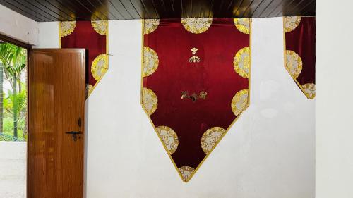 a room with a red curtain and a door at Coral Reef Malpe - Udupi in Udiyāvara