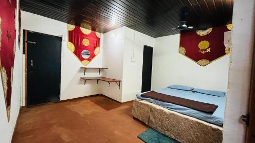 a room with a bed and a table in it at Coral Reef Malpe - Udupi in Udiyāvara