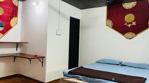 a bedroom with a bed and a table in it at Coral Reef Malpe - Udupi in Udiyāvara