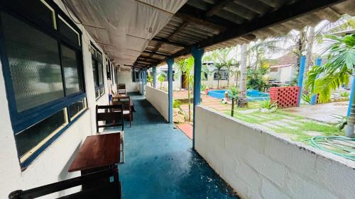 a hallway of a house with a bench and a yard at Coral Reef Malpe - Udupi in Udiyāvara