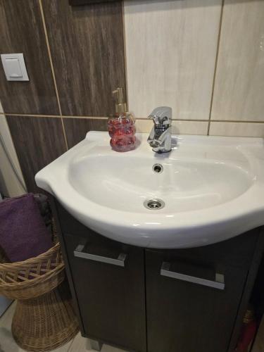 a bathroom with a white sink and a mirror at Kate Sea Apartment in Pärnu