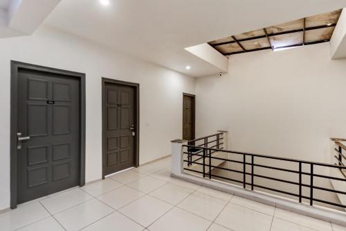a hallway with two doors and a staircase at Townhouse South City 2 Sector 49 Gurgaon in Gurgaon