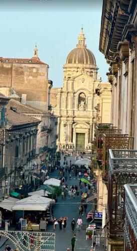 a large building with a crowd of people in front of it at Asmundo Palace Suites & Spa in Catania