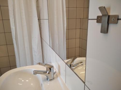 a bathroom with a sink and a mirror at Trafo Base Camp in Kroczyce