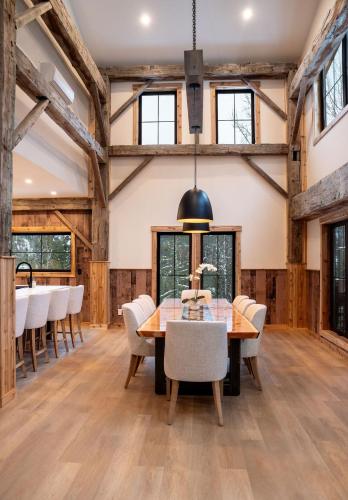a dining room with a wooden table and chairs at Boulder Mountain Resort in Revelstoke