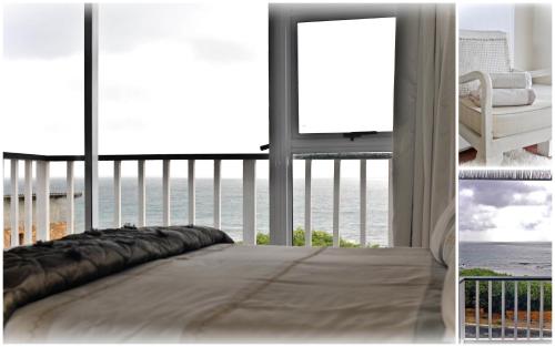 a bedroom with a bed and a view of the ocean at The Bay Lodge in Gansbaai