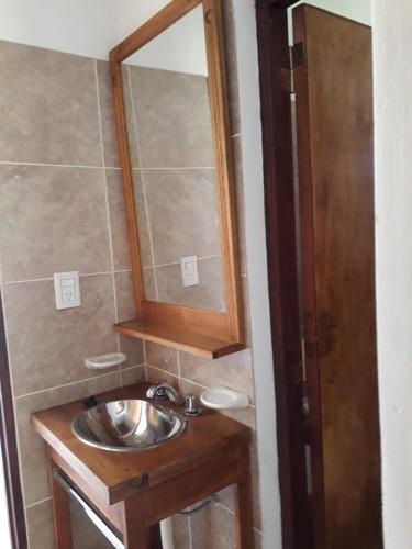 a bathroom with a sink and a mirror at Cabañas El Descanso de Animaná in Animaná