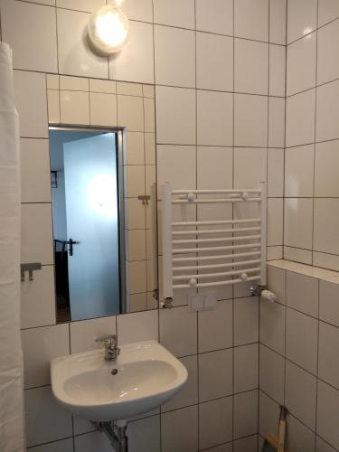 a bathroom with a sink and a mirror at Trafo Base Camp in Kroczyce
