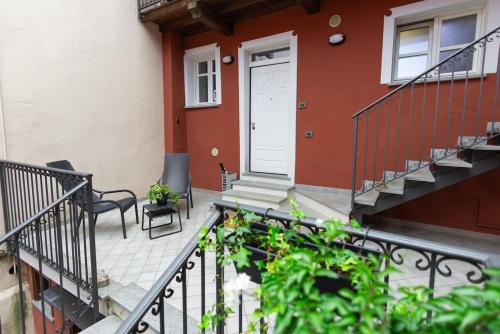 a balcony of a house with a white door at Casa Azzura Bilocale chic a due passi dal Duomo in Pinerolo