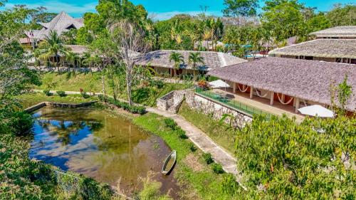 an aerial view of a resort with a pond at Hotel Villa Mercedes Palenque in Palenque