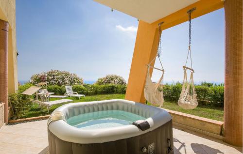 a jacuzzi tub sitting on a patio next to a window at Amazing Home In Belmonte Calabro in Belmonte Calabro