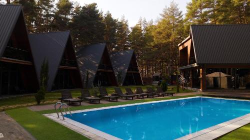 a swimming pool in front of a building at Park Hotel Surami Chalet in Surami