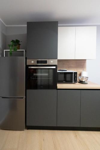 a kitchen with black and white appliances in a room at Suite delle Maree in Chioggia