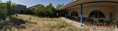 a building with a bunch of plants in a garden at Welcome to Ashtarak in Ashtarak