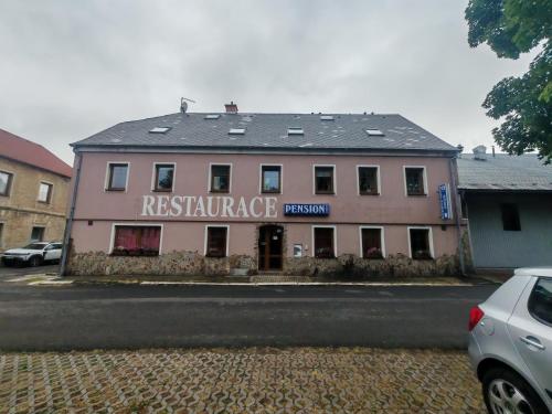a building with a restaurant on the side of a street at Nord in Hora Svatého Šebestiána