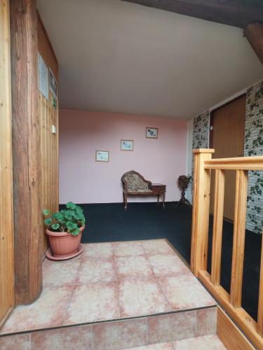 a room with a table and a potted plant at Nord in Hora Svatého Šebestiána