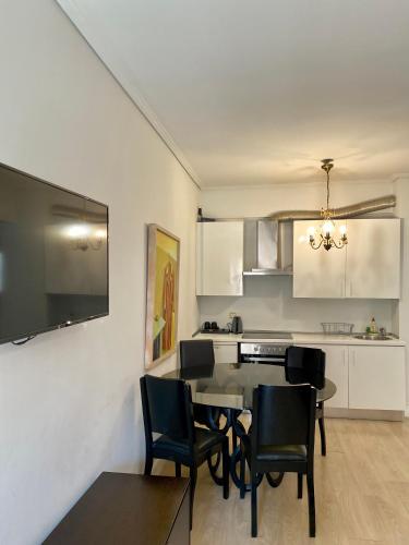 a kitchen and dining room with a table and chairs at Art Suites Athens in Athens