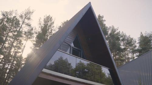 a window on the side of a house with trees at Park Hotel Surami Chalet in Surami