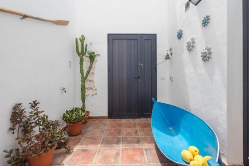 a blue umbrella sitting in front of a door at Lightbooking La Graciosa in Caleta de Sebo