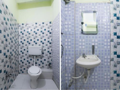 a bathroom with a toilet and a sink at Hotel O Home Cozy Studio Collage Square Hotel Maya International Near St. Thomas's Church in Kolkata