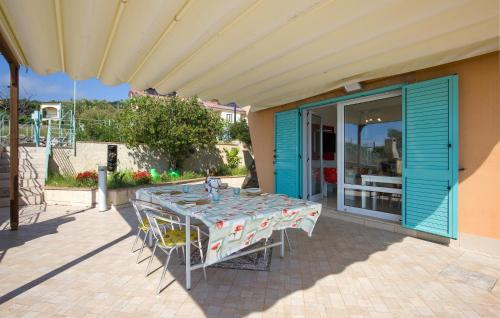 a table and chairs sitting on a patio at Amazing Home In Belmonte Calabro in Belmonte Calabro