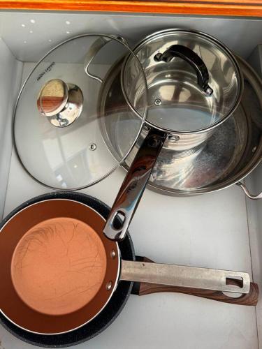 a frying pan and a pot on a stove at Murdeira V17 RC by RPG Group in Beirona