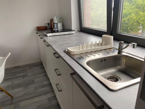 a kitchen counter with a sink and a window at Apartament Zoom 42 in Bydgoszcz