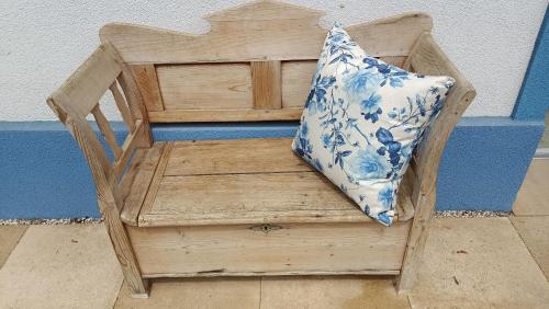 a wooden chair with a pillow on top of it at Nationalpark Bauernhaus in Apetlon