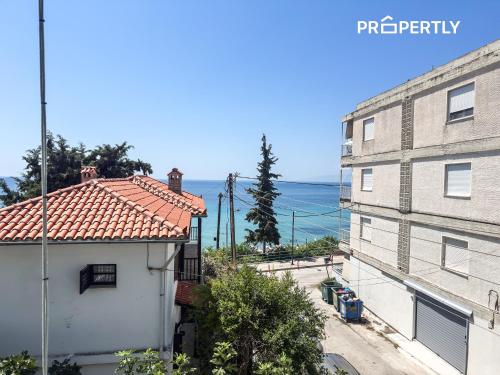 an apartment building with a view of the ocean at Blue Seaview Apartment #PROPERTLY in Nea Kalikratia