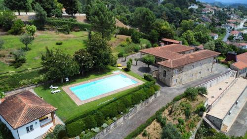 an aerial view of a house with a swimming pool at Nomad's Country - Casa Cimo de Vila in Pedraça