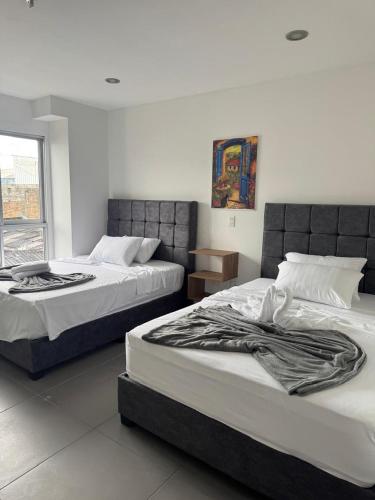 Cama o camas de una habitación en Hotel San Miguel src