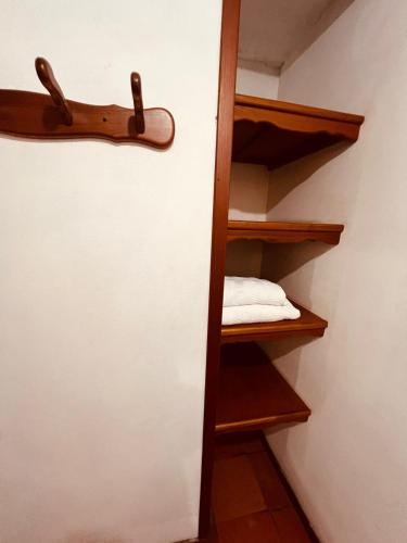a room with a closet with wooden shelves at Aura Hotel Parque Barichara By Infinity in Barichara