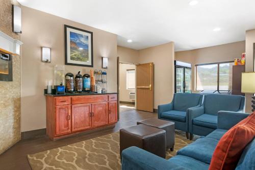 a living room with two blue chairs and a couch at Comfort Inn North - Air Force Academy Area in Colorado Springs