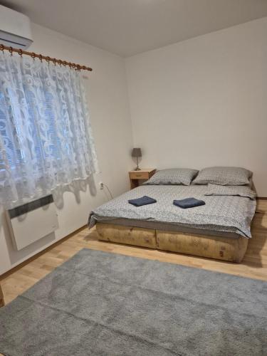 a bedroom with a bed with two pillows on it at Apartmany-Anna in Podhájska