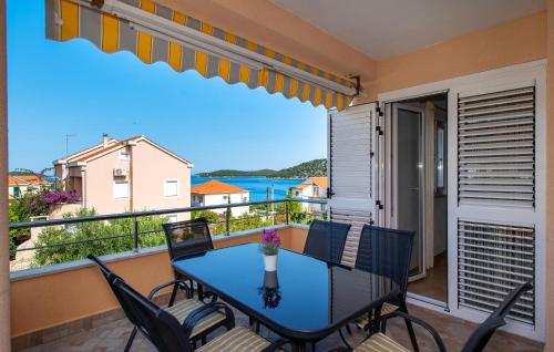 a balcony with a table and chairs and a view of the water at Gorgeous Apartment In Razanj With Wifi in Ražanj
